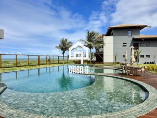 Apartamento mobiliado térreo com 3 suítes frontal mar a venda no condomínio Bali Exclusive em Itacimirim Bahia