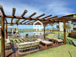 Apartamento mobiliado térreo com 3 suítes frontal mar a venda no condomínio Bali Exclusive em Itacimirim Bahia