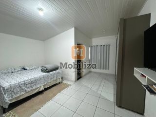 Casa com 5 dormitórios sendo 1 suíte e piscina no bairro Aponiã 180m²