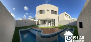 Casa 4 suítes no Alphaville Litoral Norte 2, 294m², pé-direito duplo, piscina e arquitetura moderna
